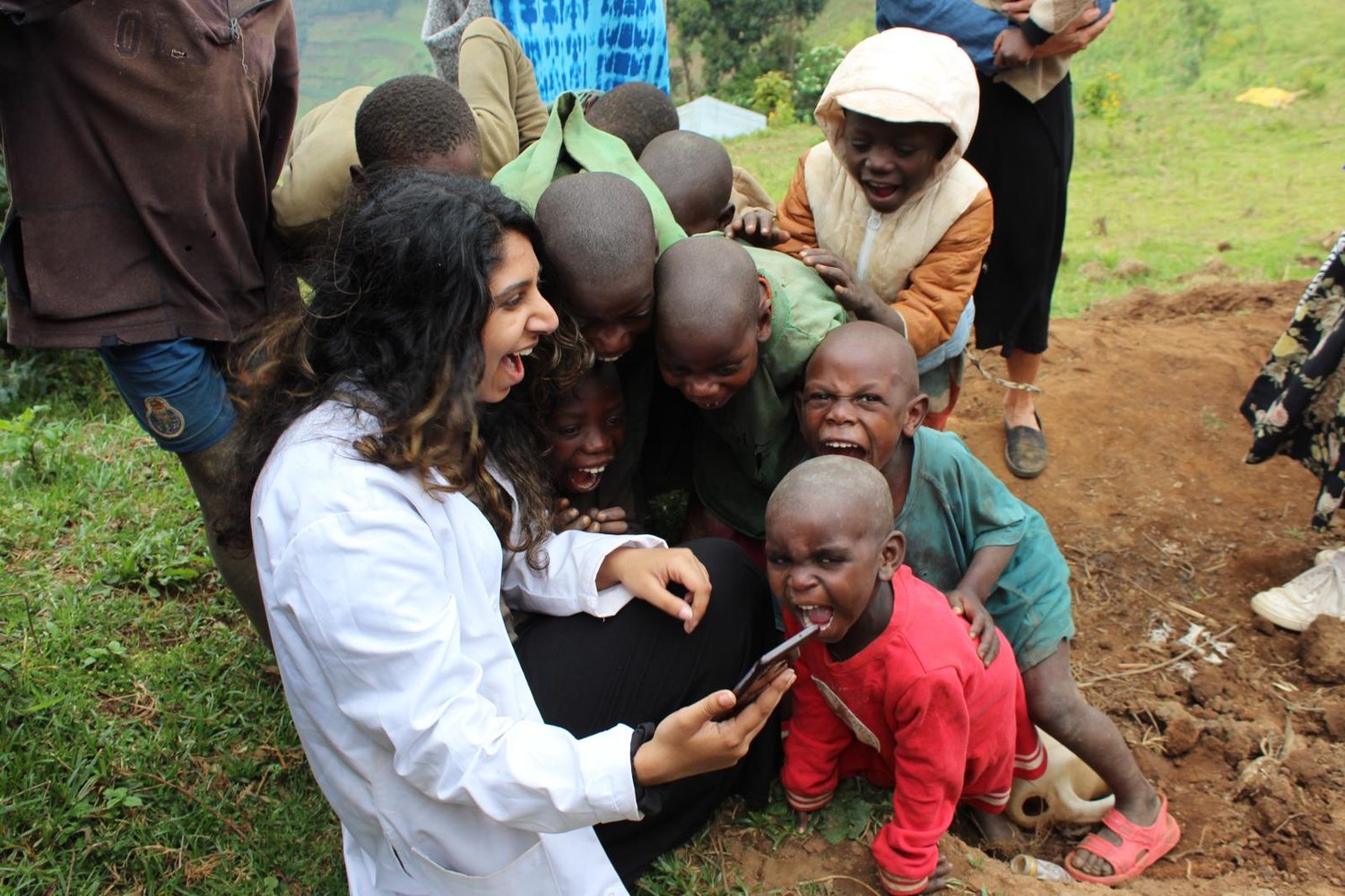 Fortiva's founder with children from the Batwa community in Uganda