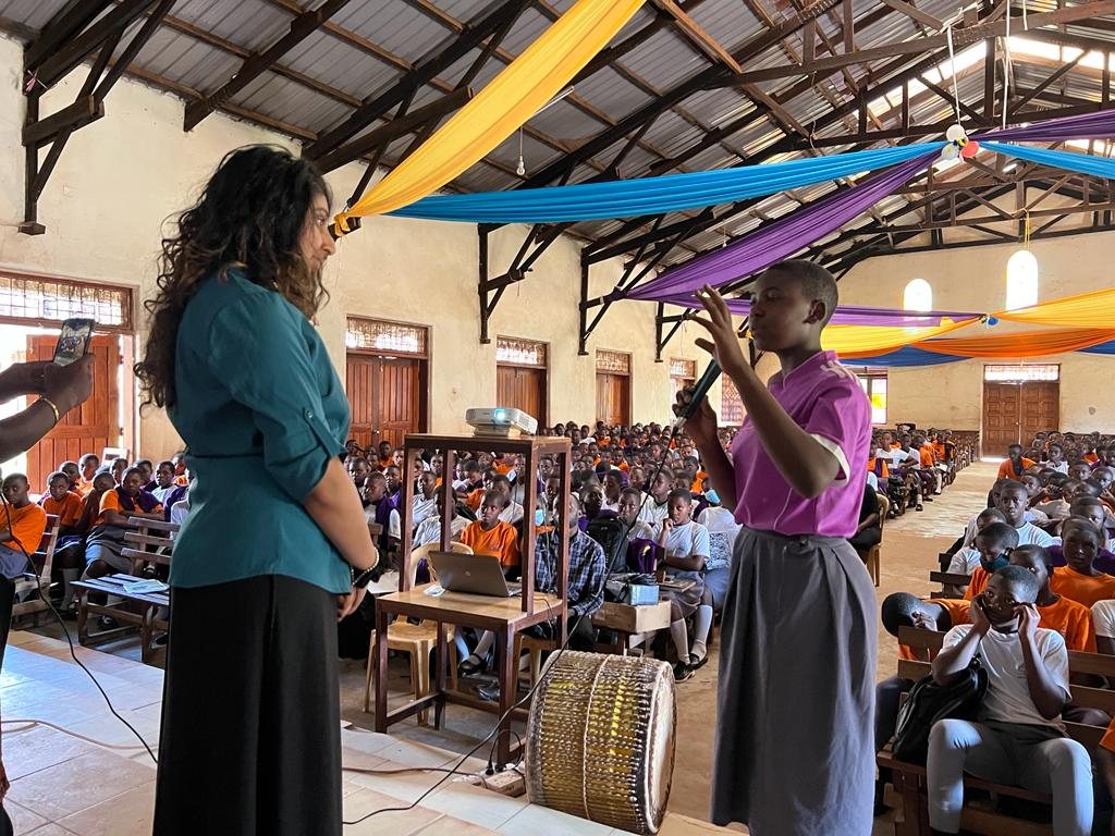 Alyna delivering health education to students at a school in Uganda